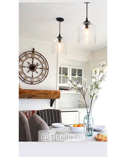 Black metal Jeffery Style Shelf Bracket by Industrial Farm Co supporting rustic wood floating shelf in modern farmhouse ki...