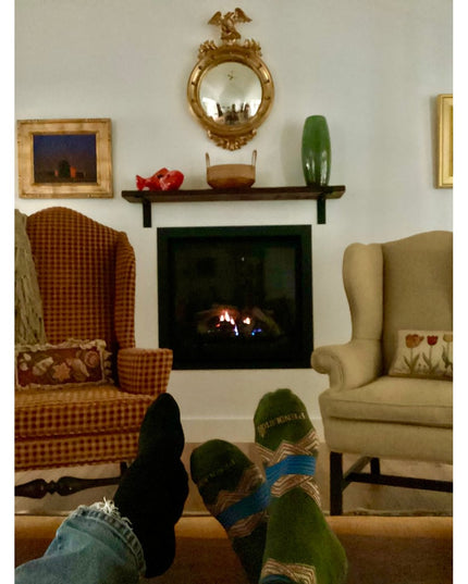 Black metal Auburn Z Open Shelf Support brackets holding dark wood mantel shelf above fireplace in cozy living room with w...