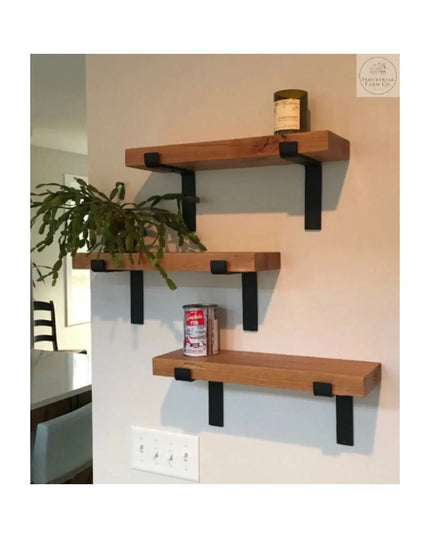 Auburn Z Open Shelf Support by Industrial Farm Co - three floating wood shelves with black metal L-brackets mounted on whi...