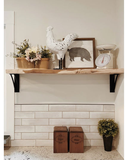 Black metal Niagara Bracket Support from Industrial Farm Co holding rustic wood shelf with farmhouse decor in kitchen setting