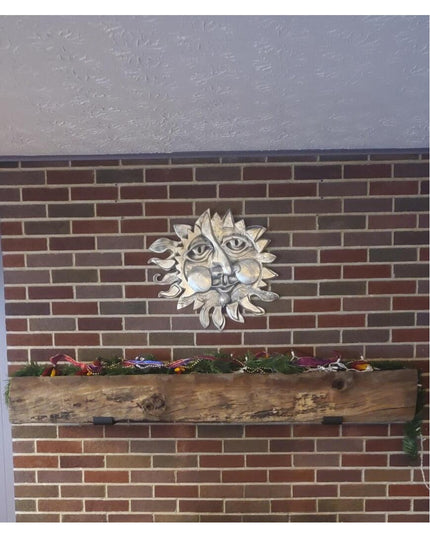 Rustic wooden shelf with decorative metal sun face wall art mounted on red brick wall using black metal J-brackets from In...