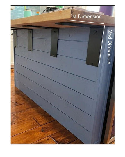 Gray kitchen island with black metal Lorraine L shelf brackets supporting wooden countertop, showing heavy duty steel supp...