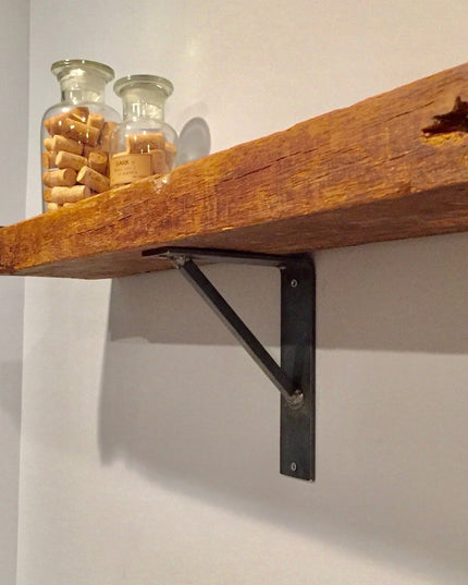Oneida black metal shelf bracket supporting reclaimed wood floating shelf with glass jars containing wine corks - Industri...