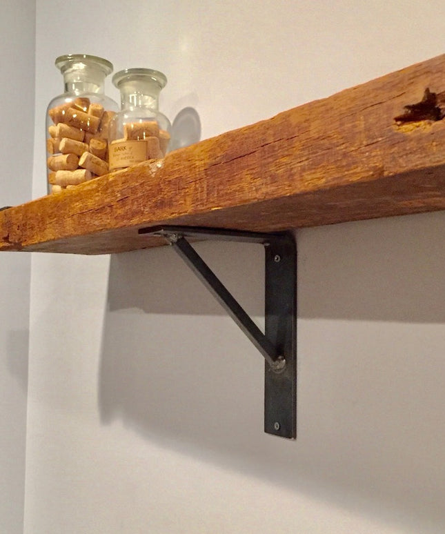 Oneida black metal shelf bracket supporting reclaimed wood floating shelf with glass jars containing wine corks - Industri...
