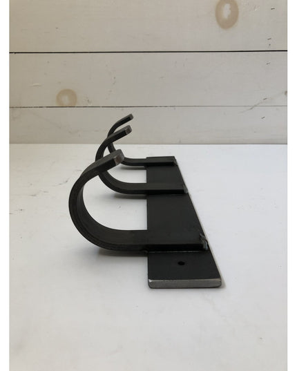 Black metal Mary Style handmade coat rack by Industrial Farm Co with curved hook design on rectangular base against white ...