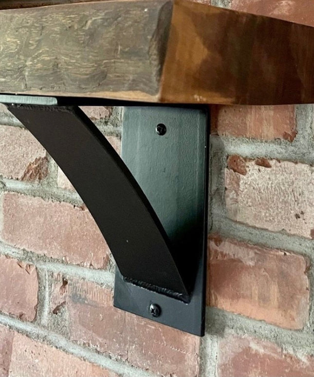 Black steel Albany 4 inch industrial shelf bracket with curved support bar mounted on brick wall supporting reclaimed wood...