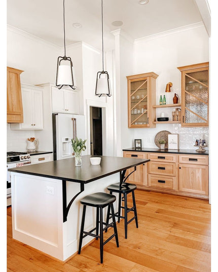 Black metal Syracuse countertop support brackets from Industrial Farm Co holding up dark kitchen island countertop with tw...