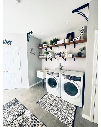 Black metal Nauseef shelf support brackets from Industrial Farm Co holding wooden shelves in modern farmhouse laundry room