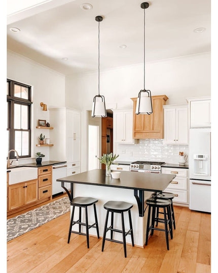 Black metal Syracuse Countertop Supports by Industrial Farm Co supporting kitchen island with dark countertop and bar stoo...