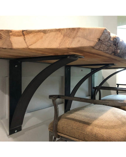 The Andrew Countertop Support black metal shelf brackets with curved design supporting live edge wood countertop in modern...