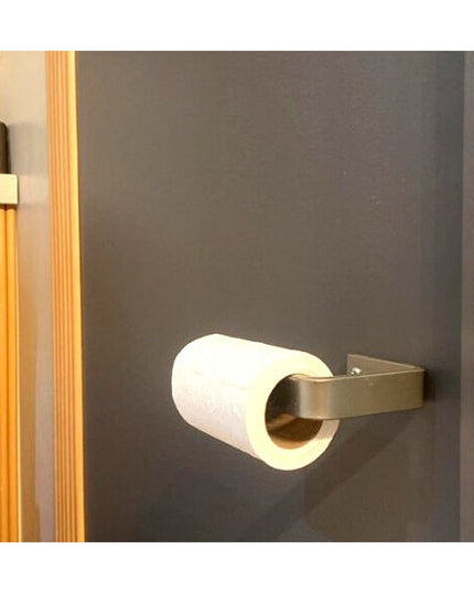 Manlius minimalist stainless steel toilet paper holder mounted on gray bathroom wall with white toilet paper roll by Indus...