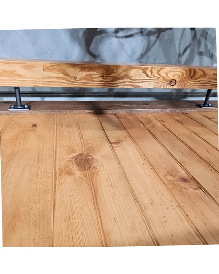 Black metal bar foot rail brackets supporting natural wood beam rail on light wood plank flooring - Industrial Farm Co har...