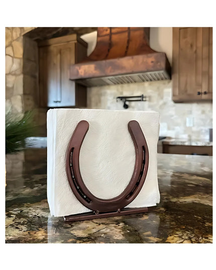 Industrial Farm Co rustic brown horseshoe napkin holder displaying white napkins on granite countertop in farmhouse kitchen