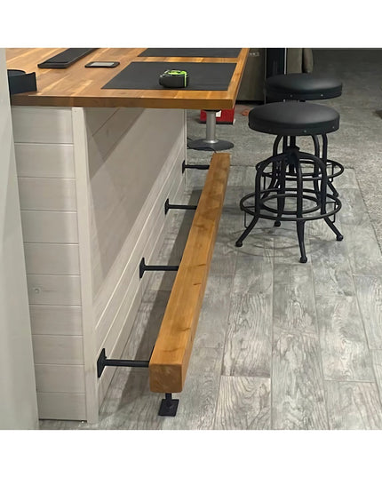 Black metal bar foot rail brackets mounted under kitchen island with wood beam footrest, Industrial Farm Co hardware