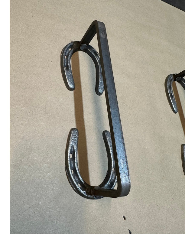 Black wrought iron horseshoe door handle by Industrial Farm Co, featuring rustic Chincoteague Pony Shoe design with curved...