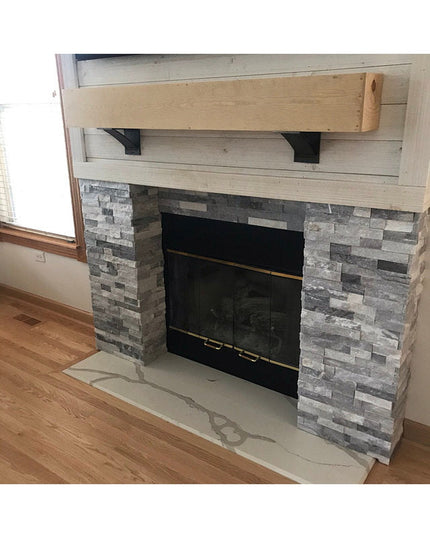 Black steel Industrial Farm Co Albany 4-inch shelf brackets supporting rustic wood mantel above stone fireplace with shipl...