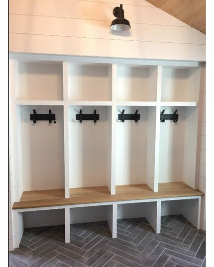 White built-in mudroom cubby system with wood bench, black metal coat hooks, and upper storage compartments - The Fairmoun...