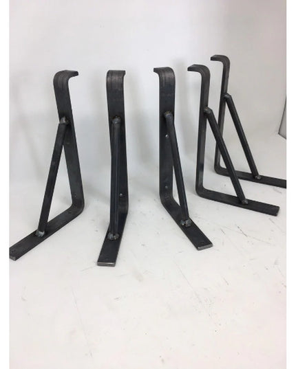 Black metal triangular shelf support brackets by Industrial Farm Co, showing angular geometric design with curved tops and...