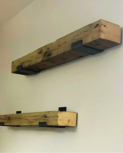 Rustic reclaimed wood floating shelves with black metal brackets mounted on white wall showing natural wood grain and weat...