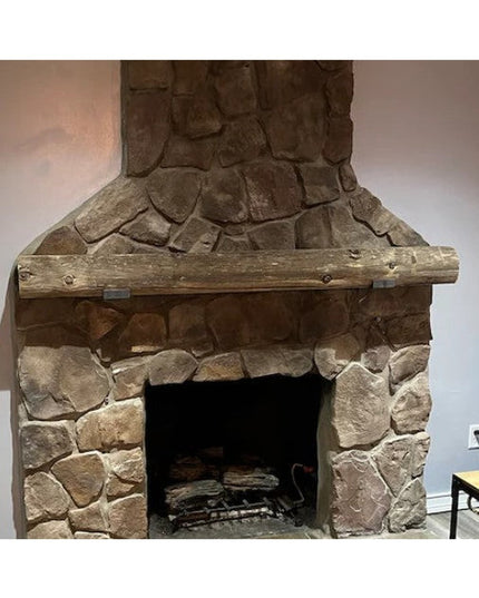 Rustic wood beam mantel shelf with metal brackets mounted on stone fireplace, showing The Glimmerglass J Shelf by Industri...