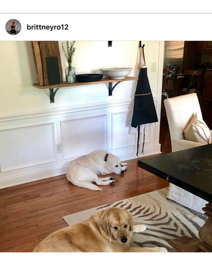 Black metal industrial shelf brackets supporting wooden floating shelf with white bowls in modern farmhouse kitchen with t...