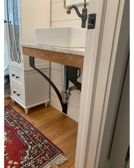 Industrial Farm Co Rochester black metal countertop brackets supporting white marble vanity with vessel sink in modern far...