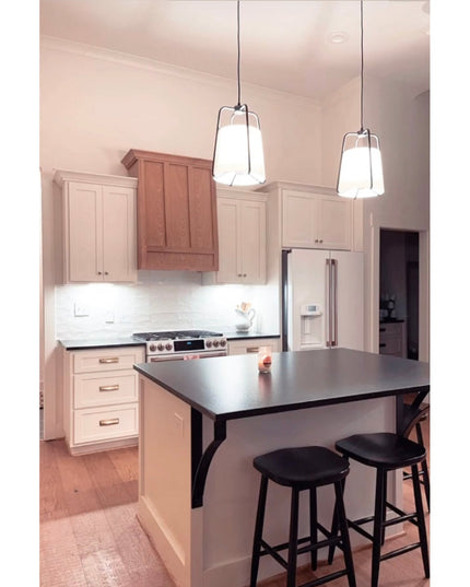 Black metal Syracuse countertop support brackets from Industrial Farm Co supporting dark granite kitchen island with bar s...