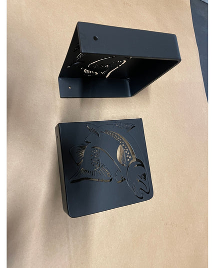 Black metal Vandiver Trout Mantel End Caps by Industrial Farm Co featuring carved fish design, shown assembled and separat...