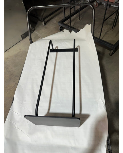 Black metal Diana towel rack with shelf by Industrial Farm Co displayed on white fabric, featuring minimalist industrial d...