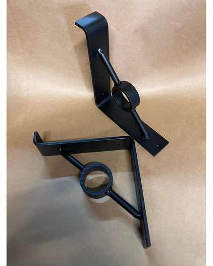 Black metal Simon Decorative Support Brackets by Industrial Farm Co, featuring curved design with circular ring details an...