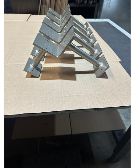 Stainless steel bar foot rail brackets by Industrial Farm Co displayed on wooden surface, showing L-shaped mounting hardwa...