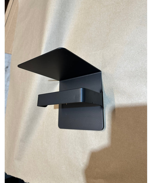 Black metal Cazenovia toilet paper holder with shelf by Industrial Farm Co mounted on white wall, featuring modern industr...