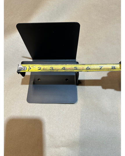 Gray metal Cazenovia toilet paper holder with shelf being measured with tape measure showing 6-inch width by Industrial Fa...