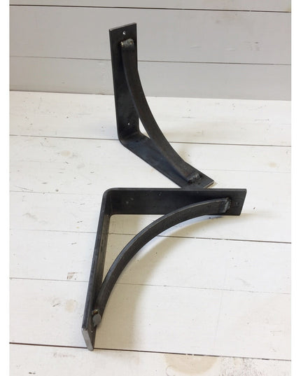 Black steel industrial shelf brackets with curved support bars from Industrial Farm Co, handmade heavy duty design on whit...