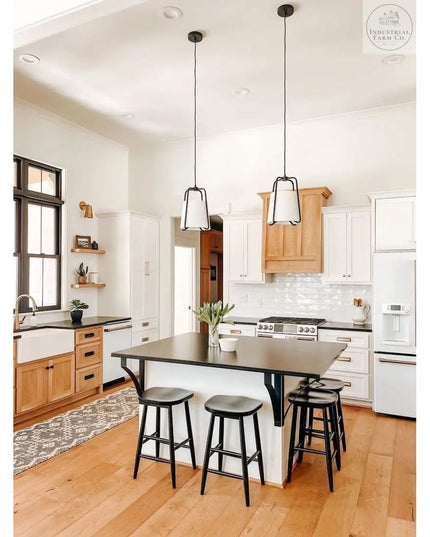 Black metal Syracuse countertop support brackets from Industrial Farm Co holding up kitchen island with natural wood and w...