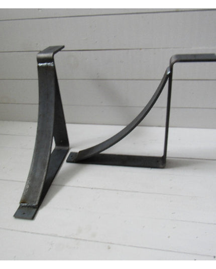 Black metal Marietta shelf bracket corbels by Industrial Farm Co with curved support design on white wood background