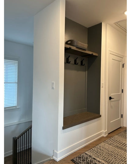 Black metal Elizabeth Wall Hook by Industrial Farm Co mounted in modern mudroom entryway with built-in bench and storage nook