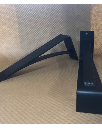 Black metal Saratoga Shelf Support Bracket by Industrial Farm Co showing modern L-shaped corbel design on wooden surface
