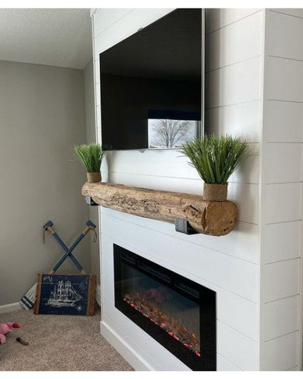 Heavy duty steel J shelf brackets supporting rustic wood beam mantel above white electric fireplace with plants and mounte...