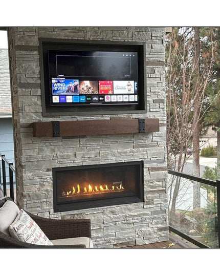 Industrial Farm Co Billings rustic brown wooden beam strap with black metal brackets mounted on stone fireplace with TV above