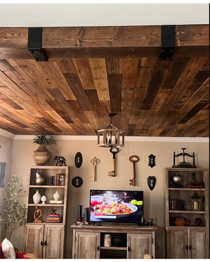 Black metal Industrial Farm Co Billings Wooden Beam Strap supporting rustic wood ceiling beam in farmhouse living room