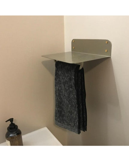 Houston Metal Wall Shelf by Industrial Farm Co in sage green with brass hardware, mounted on bathroom wall holding dark to...