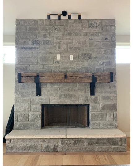 Vandiver Evergreen Tree Mantel End Caps by Industrial Farm Co mounted on gray stone fireplace with rustic wood mantel shelf