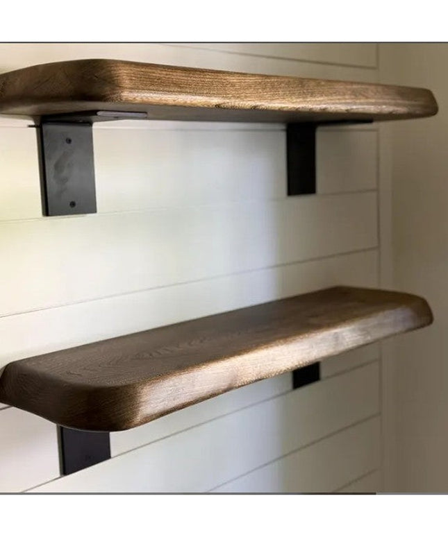Heavy duty black steel L-bracket shelf supports holding thick walnut wood floating shelves against white shiplap wall - In...
