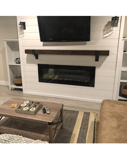 Black iron Seneca 3" Farmhouse Mantel Brackets supporting dark wood mantel above modern fireplace in white shiplap wall
