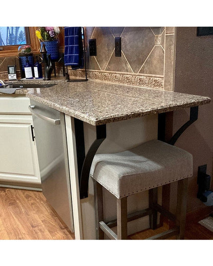 Syracuse countertop support brackets in black metal supporting granite breakfast bar with beige upholstered stools in mode...