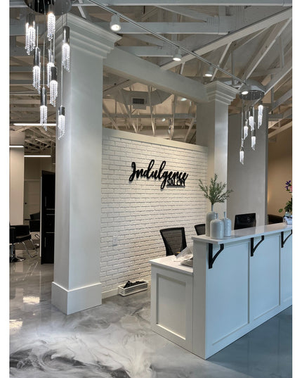 White Syracuse countertop support brackets by Industrial Farm Co mounted under modern salon reception desk with exposed ce...