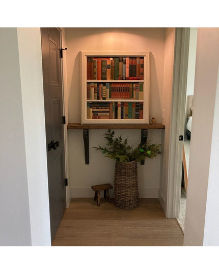 Black metal Syracuse countertop support brackets from Industrial Farm Co holding wooden shelf with books in white nook alcove