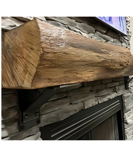 Rustic wood beam mantel supported by black metal Ithaca bracket against natural stone fireplace wall from Industrial Farm Co