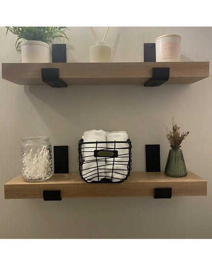 Black metal Jane J Style Shelf Brackets by Industrial Farm Co supporting wooden floating shelves with bathroom decor and t...
